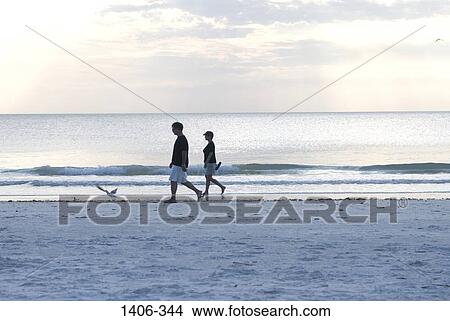 Couple walking on the beach View Large Photo Image Picture - Couple walking on the beach. Fotosearch