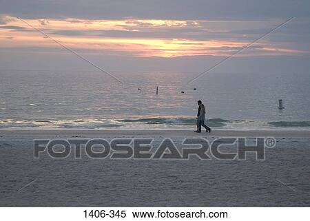Couple walking on the beach View Large Photo Image Stock Photography - Couple walking on the beach. Fotosearch