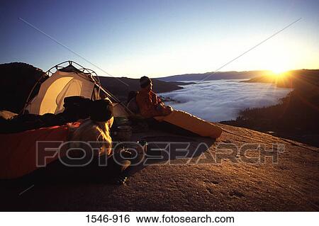 Couple watching sunrise while camping at the lakeside, Donner Lake, Truckee, Nevada County, California, USA View Large Photo Image Stock Photograph - Couple watching sunrise while camping at the lakeside, Donner Lake, Truckee, Nevada County, California, USA. Fotosearch