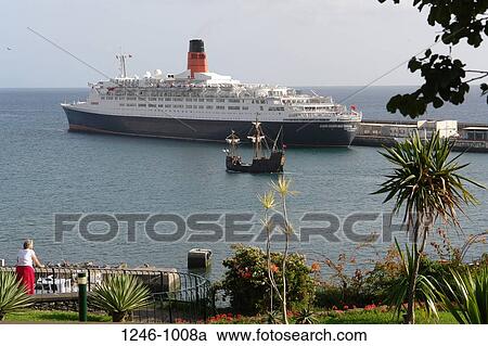 Cruise ship at the pier with a replica of Columbus' Santa Maria, RMS Queen Elizabeth 2, Funchal, Madeira, Portugal View Large Photo Image Stock Image - Cruise ship at the pier with a replica of Columbus' Santa Maria, RMS Queen Elizabeth 2, Funchal, Madeira, Portugal. Fotosearch