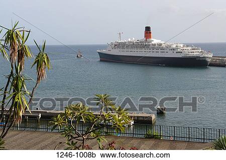 Cruise ship at the pier with a replica of Columbus' Santa Maria, RMS Queen Elizabeth 2, Funchal, Madeira, Portugal View Large Photo Image Stock Image - Cruise ship at the pier with a replica of Columbus' Santa Maria, RMS Queen Elizabeth 2, Funchal, Madeira, Portugal. Fotosearch