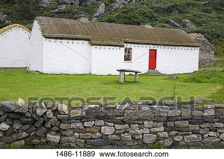 Dolmen in front of a folk museum, Folk Village Museum, Glencolmcille, County Donegal, Ulster Province, Ireland View Large Photo Image Stock Photo - Dolmen in front of a folk museum, Folk Village Museum, Glencolmcille, County Donegal, Ulster Province, Ireland. Fotosearch