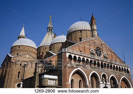 Stock Photograph - Equestrian monument of Erasmo de Narni by a basilica, Gattamelata Monument, Basilica of Saint Anthony, Padua, Veneto, Italy. Fotosearch