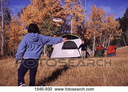 Family playing with a plastic disc at camping, Truckee, Nevada County, California, USA View Large Photo Image Stock Image - Family playing with a plastic disc at camping, Truckee, Nevada County, California, USA. Fotosearch