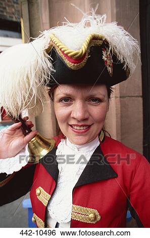 Stock Photograph - Female town crier ringing a bell, Chester, Cheshire, England. Fotosearch