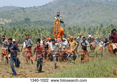 Stock Image - Group of people carrying poykuthiras in Machattu vela festival, Machattu Thiruvanikavu Temple, Wadakanchery, Thrissur District, Kerala, India. Fotosearch