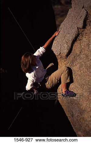 High angle view of a woman climbing a rock, The Buttermilks, California, USA View Large Photo Image Stock Photo - High angle view of a woman climbing a rock, The Buttermilks, California, USA. Fotosearch