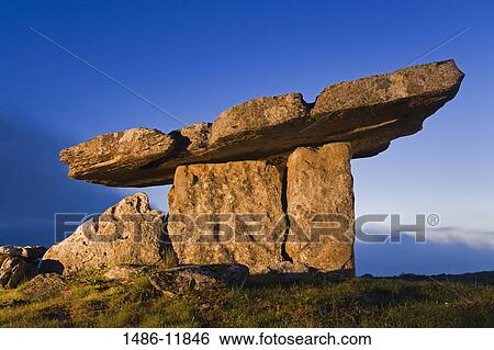 Low angle view of a megalithic stone tomb, Poulnabrone Dolmen, The Burren, County Clare, Munster Province, Republic of Ireland View Large Photo Image Stock Photograph - Low angle view of a megalithic stone tomb, Poulnabrone Dolmen, The Burren, County Clare, Munster Province, Republic of Ireland. Fotosearch