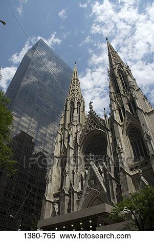 Low angle view of a skyscraper and a cathedral in a city, St. Patrick's Cathedral, Manhattan, New York City, New York State, USA View Large Photo Image Stock Photography - Low angle view of a skyscraper and a cathedral in a city, St. Patrick's Cathedral, Manhattan, New York City, New York State, USA. Fotosearch