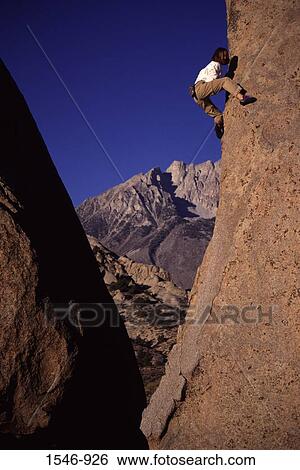 Low angle view of a woman climbing a rock, The Buttermilks, California, USA View Large Photo Image Stock Photograph - Low angle view of a woman climbing a rock, The Buttermilks, California, USA. Fotosearch