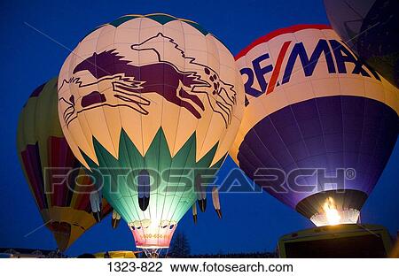Stock Image - Low angle view of hot air balloons being inflated with a propane heater, Bend, Oregon, USA. Fotosearch