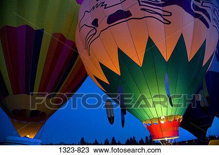 Stock Image - Low angle view of hot air balloons being inflated with a propane heater, Bend, Oregon, USA. Fotosearch