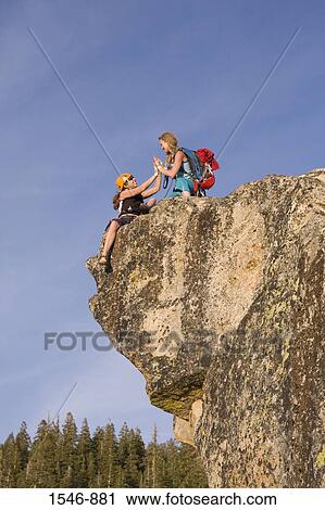 Low angle view of two female rock climbers on an overhanging cliff, Taft Point, Yosemite National Park, California, USA View Large Photo Image Stock Image - Low angle view of two female rock climbers on an overhanging cliff, Taft Point, Yosemite National Park, California, USA. Fotosearch