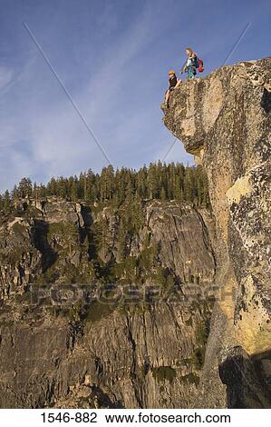 Low angle view of two female rock climbers on an overhanging cliff, Taft Point, Yosemite National Park, California, USA View Large Photo Image Stock Image - Low angle view of two female rock climbers on an overhanging cliff, Taft Point, Yosemite National Park, California, USA. Fotosearch