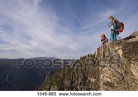 Low angle view of two female rock climbers on an overhanging cliff, Taft Point, Yosemite National Park, California, USA View Large Photo Image Stock Image - Low angle view of two female rock climbers on an overhanging cliff, Taft Point, Yosemite National Park, California, USA. Fotosearch