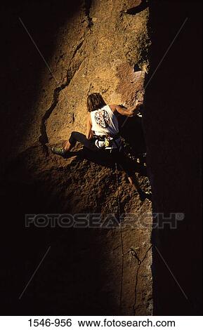 Stock Photograph - Man climbing a rock, Smith Rock, Oregon, USA. Fotosearch