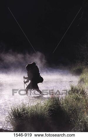 Stock Photo - Man crossing a river, Truckee River, Truckee, Nevada County, California, USA. Fotosearch