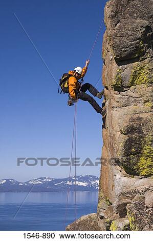 Man rappelling off a cliff, Lake Tahoe, Nevada, USA View Large Photo Image Stock Image - Man rappelling off a cliff, Lake Tahoe, Nevada, USA. Fotosearch