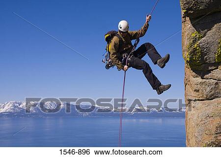 Man rappelling off a cliff, Lake Tahoe, Nevada, USA View Large Photo Image Stock Photograph - Man rappelling off a cliff, Lake Tahoe, Nevada, USA. Fotosearch
