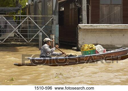 Man selling fruits on a boat, Bangkok, Thailand View Large Photo Image Stock Photograph - Man selling fruits on a boat, Bangkok, Thailand. Fotosearch