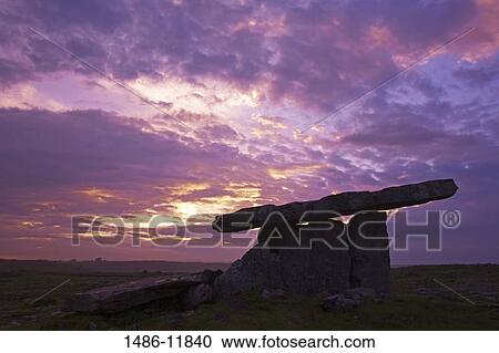 Stock Image - Megalithic stone tomb at dusk, Poulnabrone Dolmen, The Burren, County Clare, Munster Province, Republic of Ireland. Fotosearch