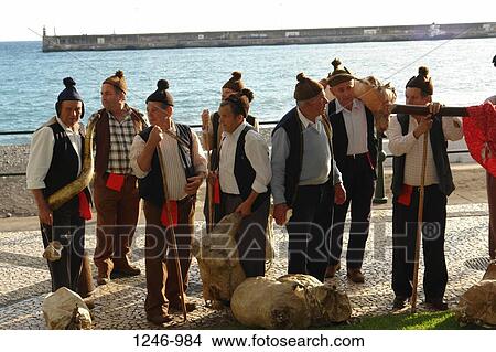 Picture - Members from a Porto da Cruz folklore group with wineskins wearing traditional caps, Funchal, Madeira, Portugal. Fotosearch