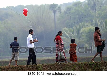Mid adult couple walking with their children, Kerala, India View Large Photo Image Stock Image - Mid adult couple walking with their children, Kerala, India. Fotosearch