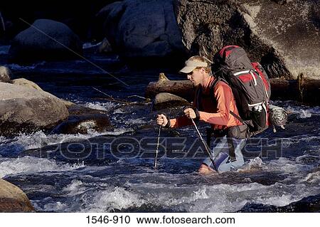 Mid adult man crossing a river, Truckee, Nevada County, California, USA View Large Photo Image Stock Image - Mid adult man crossing a river, Truckee, Nevada County, California, USA. Fotosearch