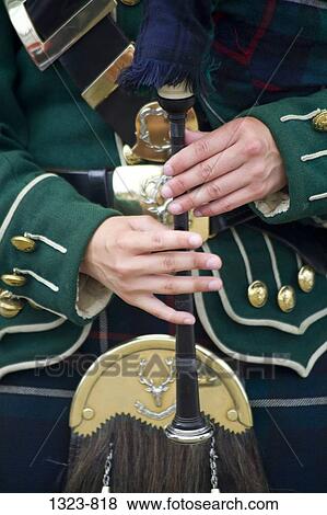 Mid section view of a woman playing a bagpipe, Scotland View Large Photo Image Stock Photo - Mid section view of a woman playing a bagpipe, Scotland. Fotosearch