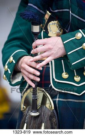 Mid section view of a woman playing a bagpipe, Scotland View Large Photo Image Stock Photo - Mid section view of a woman playing a bagpipe, Scotland. Fotosearch