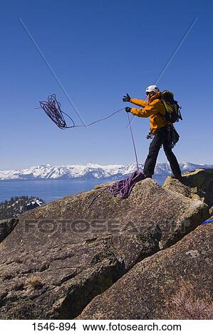 Mountaineer throwing a climbing rope off a cliff, Lake Tahoe, Nevada, USA View Large Photo Image Picture - Mountaineer throwing a climbing rope off a cliff, Lake Tahoe, Nevada, USA. Fotosearch