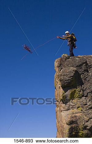 Mountaineer throwing a climbing rope off a cliff, Lake Tahoe, Nevada, USA View Large Photo Image Stock Image - Mountaineer throwing a climbing rope off a cliff, Lake Tahoe, Nevada, USA. Fotosearch