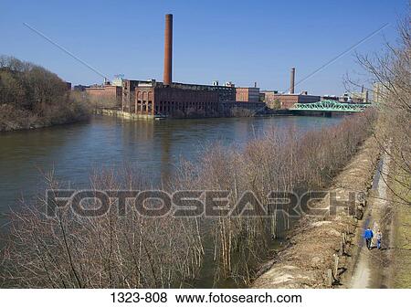 Old textile factories on the riverbank, Merrimack river, Lowell, Middlesex County, Massachusetts, USA View Large Photo Image Stock Photo - Old textile factories on the riverbank, Merrimack river, Lowell, Middlesex County, Massachusetts, USA. Fotosearch