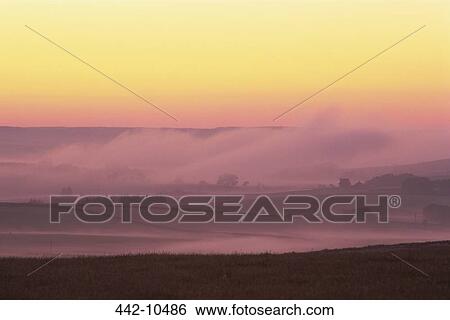 Panoramic view of fog covered landscape at dusk, Northumbria, England View Large Photo Image Stock Photograph - Panoramic view of fog covered landscape at dusk, Northumbria, England. Fotosearch