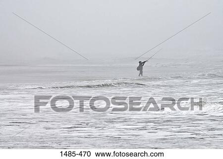 Stock Image - Person fishing in the ocean, California, USA. Fotosearch