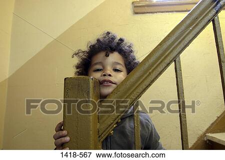 Portrait of a boy on a staircase View Large Photo Image Stock Photo - Portrait of a boy on a staircase. Fotosearch