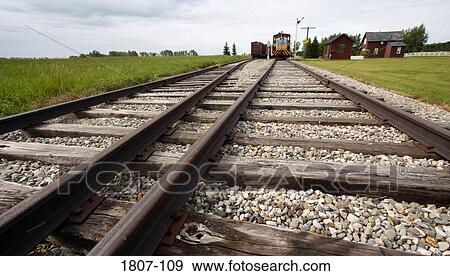 Railroad tracks with trains in the background View Large Photo Image Stock Photo - Railroad tracks with trains in the background. Fotosearch