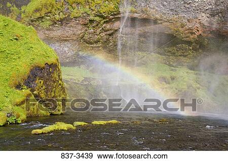 Stock Photo - Rainbow formed at a waterfall. Fotosearch