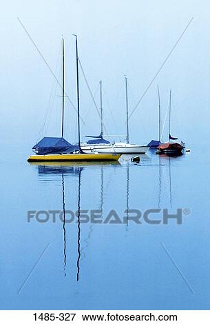 Reflection of boats in water View Large Photo Image Stock Photo - Reflection of boats in water. Fotosearch