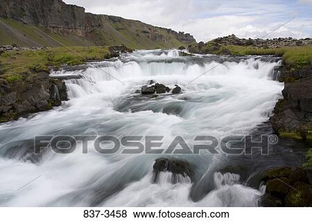 River flowing through mountains, Iceland View Large Photo Image Stock Photo - River flowing through mountains, Iceland. Fotosearch
