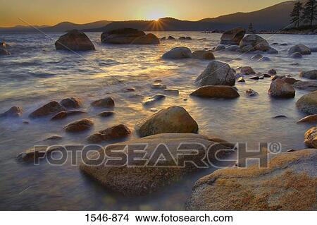 Rocks in a lake at sunset, East Shore, Lake Tahoe, Nevada, USA View Large Photo Image Picture - Rocks in a lake at sunset, East Shore, Lake Tahoe, Nevada, USA. Fotosearch