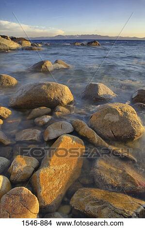Rocks in a lake at sunset, East Shore, Lake Tahoe, Nevada, USA View Large Photo Image Picture - Rocks in a lake at sunset, East Shore, Lake Tahoe, Nevada, USA. Fotosearch