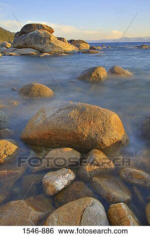 Rocks in a lake at sunset, East Shore, Lake Tahoe, Nevada, USA View Large Photo Image Stock Photograph - Rocks in a lake at sunset, East Shore, Lake Tahoe, Nevada, USA. Fotosearch