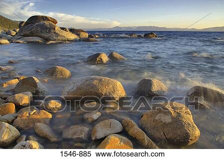 Rocks in a lake at sunset, East Shore, Lake Tahoe, Nevada, USA View Large Photo Image Stock Photography - Rocks in a lake at sunset, East Shore, Lake Tahoe, Nevada, USA. Fotosearch