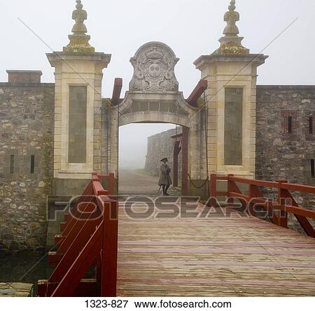 Security guard standing at the entrance of a fort, Louisbourg, Cape Breton Island, Nova Scotia, Canada View Large Photo Image Stock Photo - Security guard standing at the entrance of a fort, Louisbourg, Cape Breton Island, Nova Scotia, Canada. Fotosearch