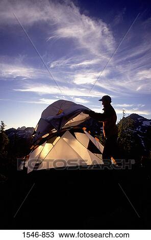 Silhouette of a man setting up a tent while hiking, Maple Pass, Washington State, USA View Large Photo Image Stock Image - Silhouette of a man setting up a tent while hiking, Maple Pass, Washington State, USA. Fotosearch