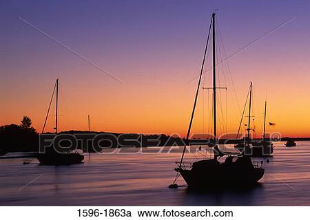 Silhouette of fishing boats in a river at dusk, Newbury Port, Essex County, Massachusetts, USA View Large Photo Image Stock Image - Silhouette of fishing boats in a river at dusk, Newbury Port, Essex County, Massachusetts, USA. Fotosearch