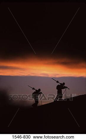 Silhouette of two skiers hiking at sunset after a storm while skiing, Mt Hood, Mt Hood National Park, Oregon, USA View Large Photo Image Stock Image - Silhouette of two skiers hiking at sunset after a storm while skiing, Mt Hood, Mt Hood National Park, Oregon, USA. Fotosearch