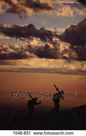 Silhouette of two skiers hiking at sunset after a storm while skiing, Mt Hood, Mt Hood National Park, Oregon, USA View Large Photo Image Stock Image - Silhouette of two skiers hiking at sunset after a storm while skiing, Mt Hood, Mt Hood National Park, Oregon, USA. Fotosearch