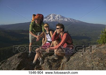 Three hikers on a mountain summit, Mt Adams, Washington State, USA View Large Photo Image Picture - Three hikers on a mountain summit, Mt Adams, Washington State, USA. Fotosearch